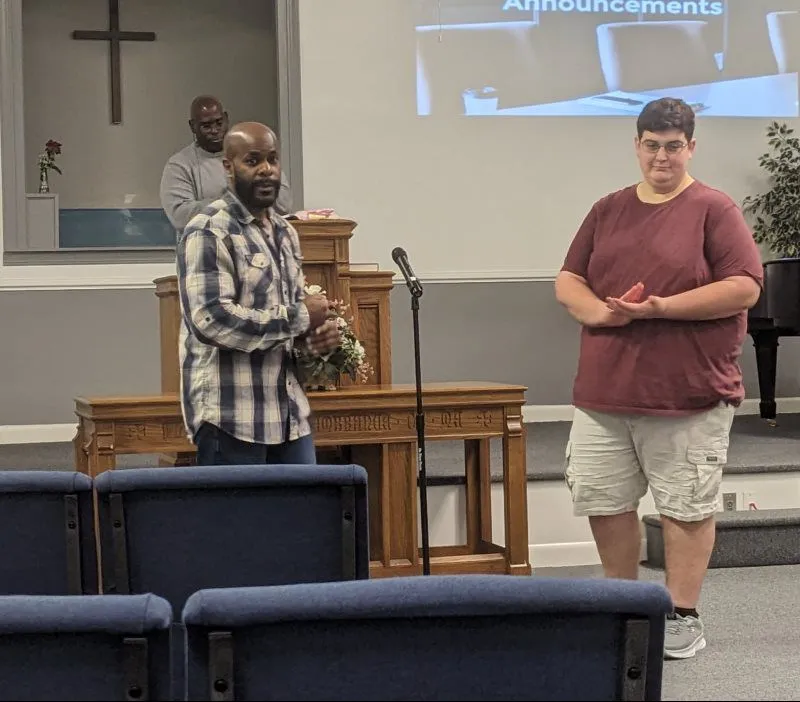 Members serving at the front of the church during worship