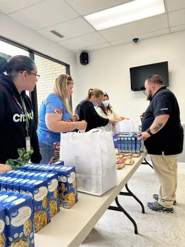 Volunteers carrying donated supplies outdoors